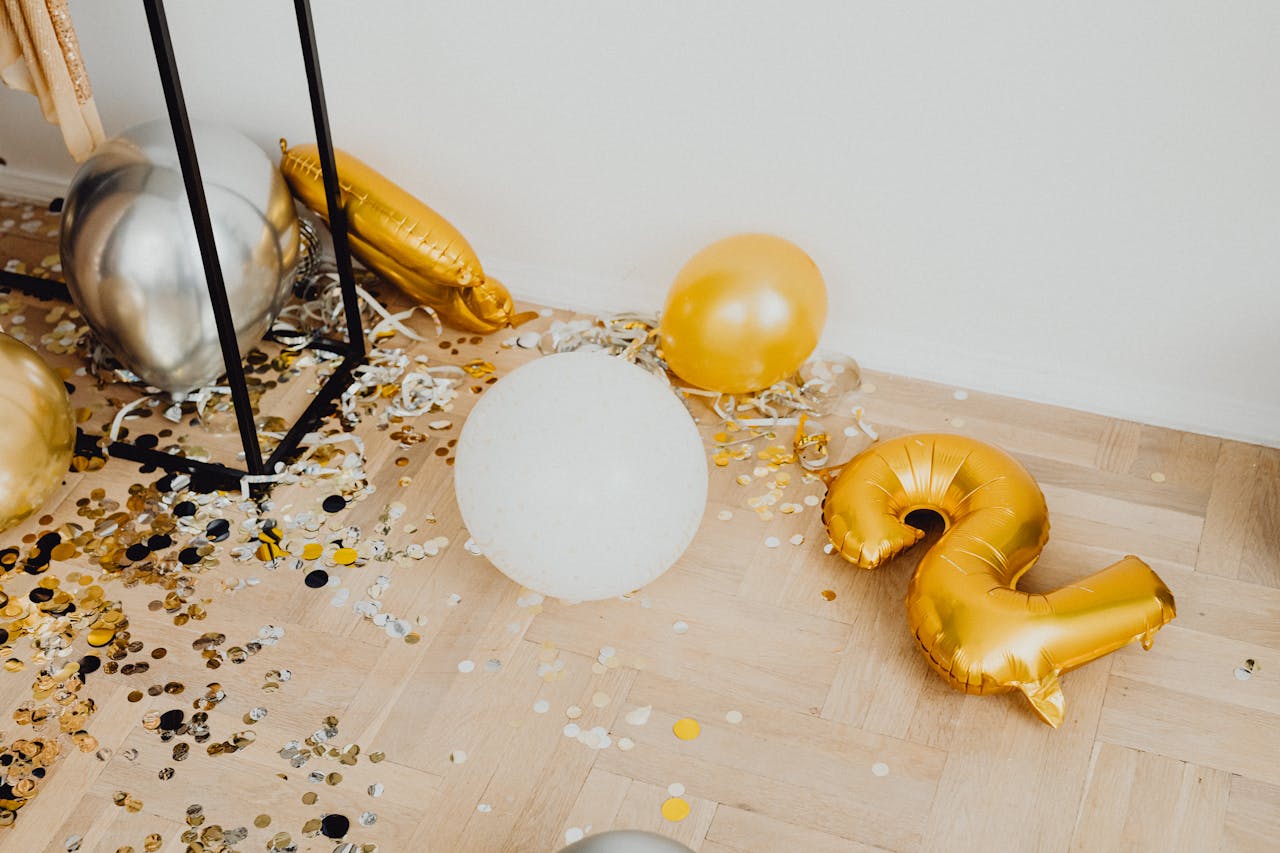 Decorative balloons and confetti on the floor, perfect for celebrations and New Year parties.